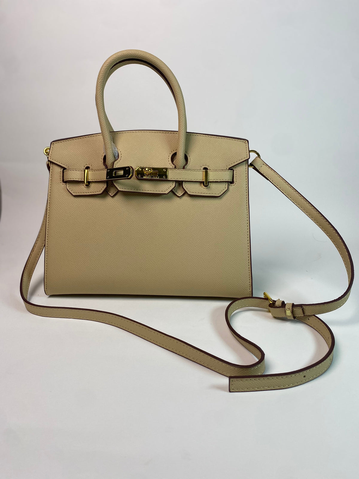 Front view of Birkin 30 cm handbag on white background.